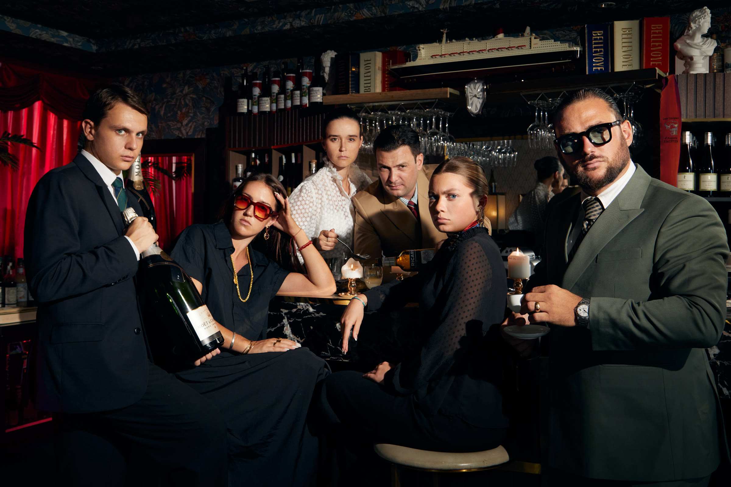 Cabanon Palace press portrait — editorial group at the bar